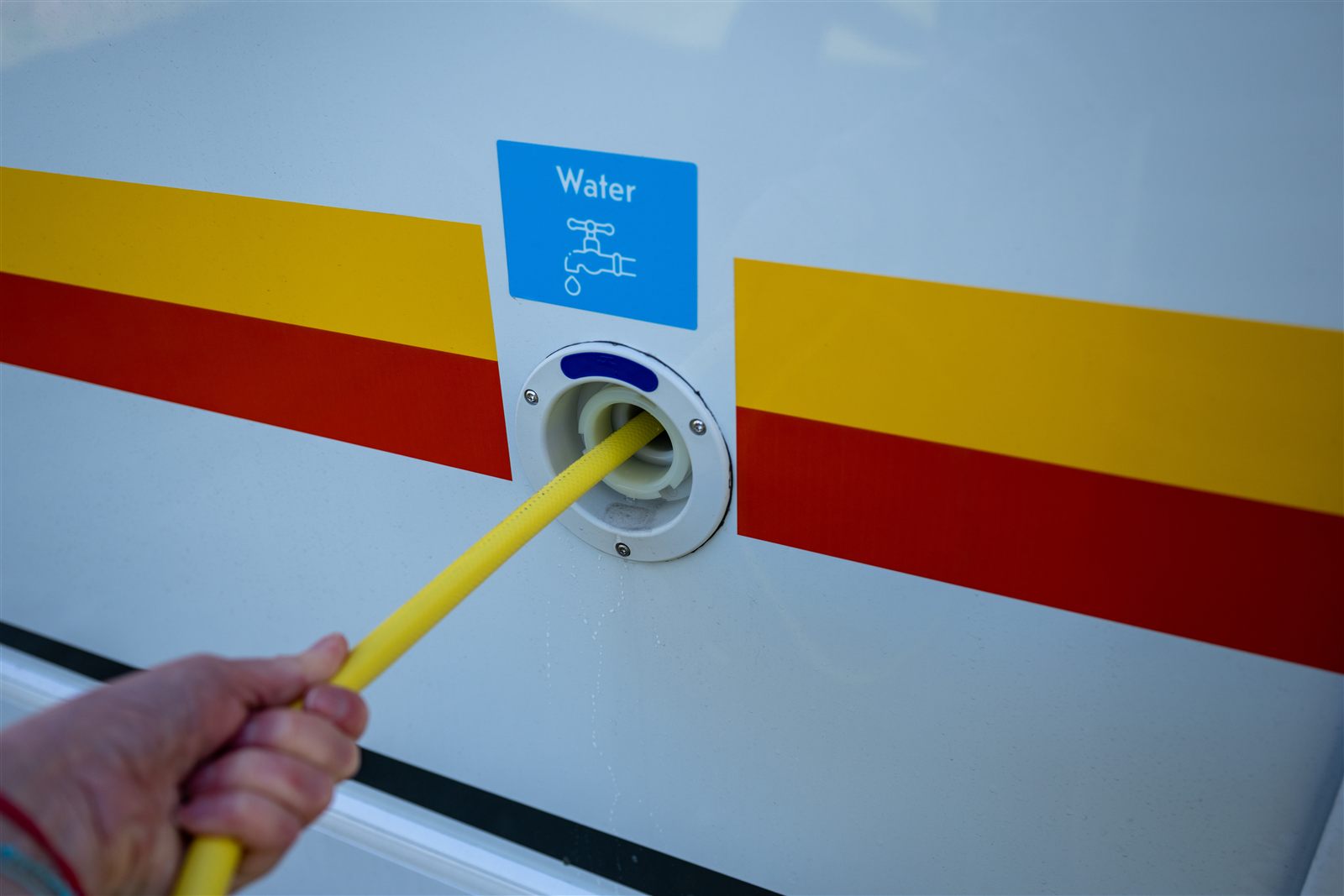 Fresh-water hose connected to an RV water inlet