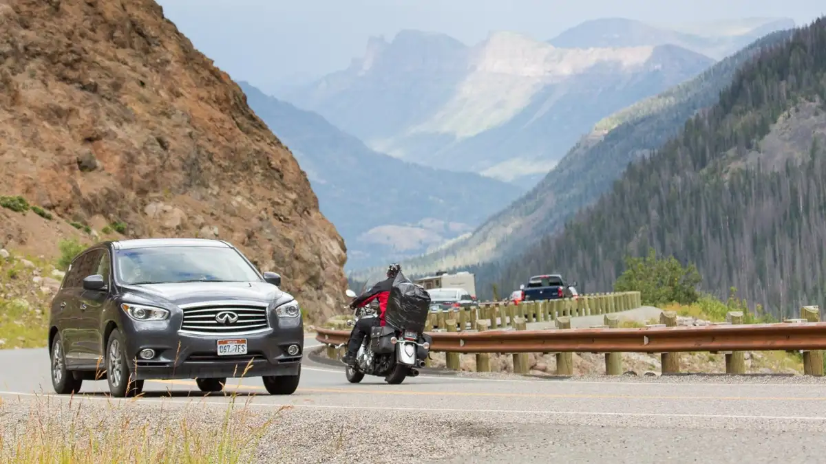 Cars and motorcycles climbing the switchbacks of Sylvan Pass on the East Entrance Road in Yellowstone National Park